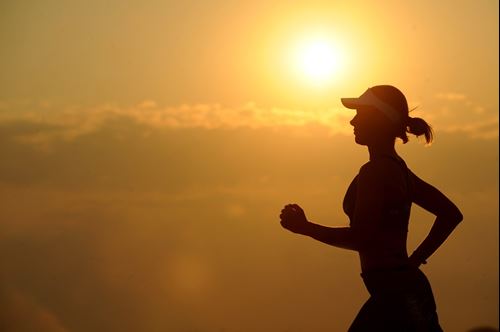 Woman running in sunset