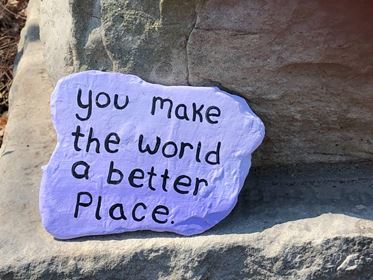 Πέτρα που γράφει το μήνυμα "You make the world a better place"